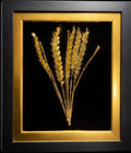 A trio of gilded wheat ears in a frame